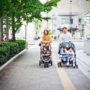 Parents pushing children in a stroller on vacation