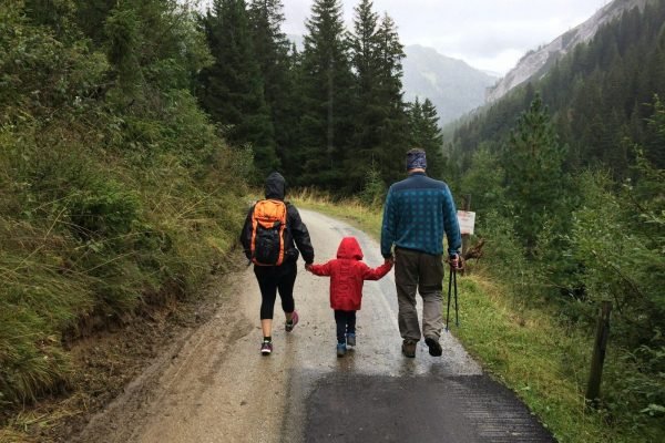 Parents and child walking together on an autumn trip