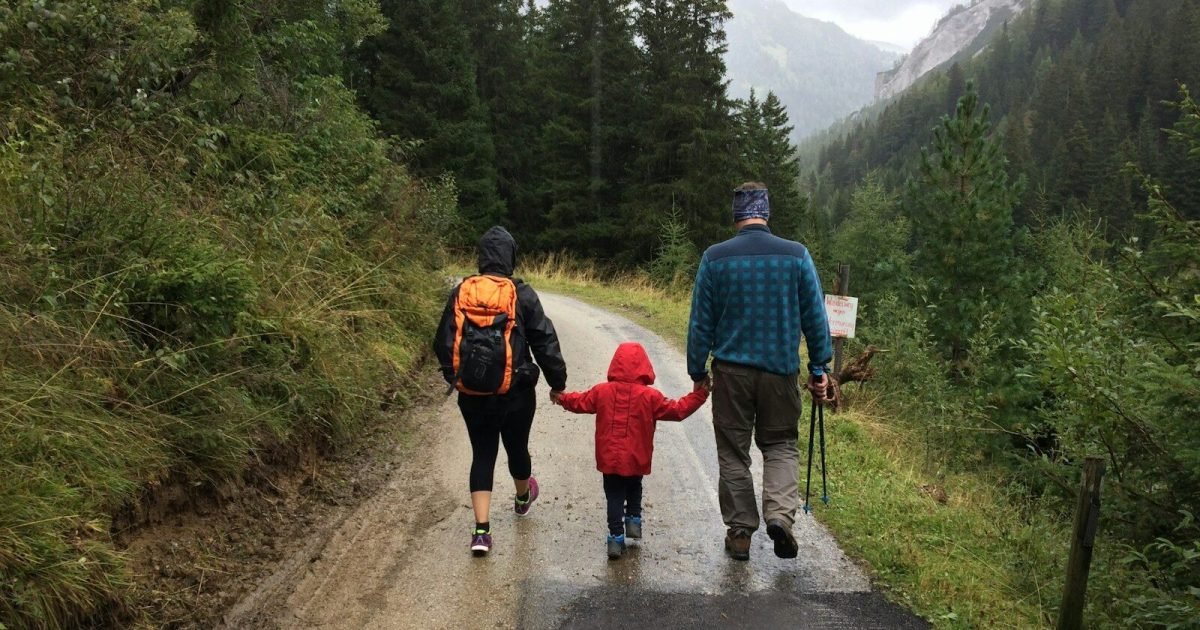 Parents and child walking together on an autumn trip