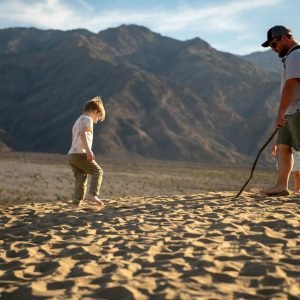 Father and children hiking on sandstone in a national park