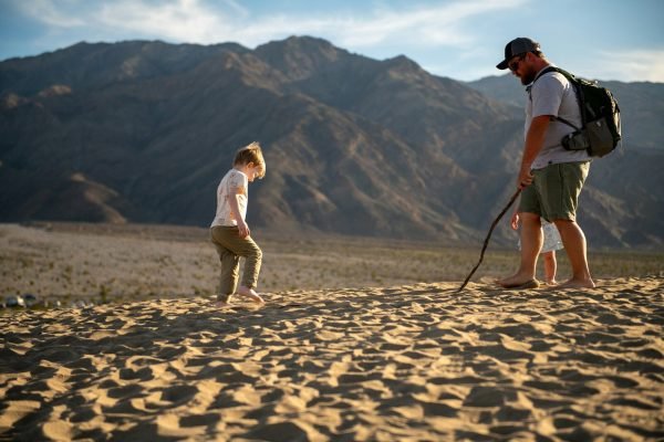 Father and children hiking on sandstone in a national park