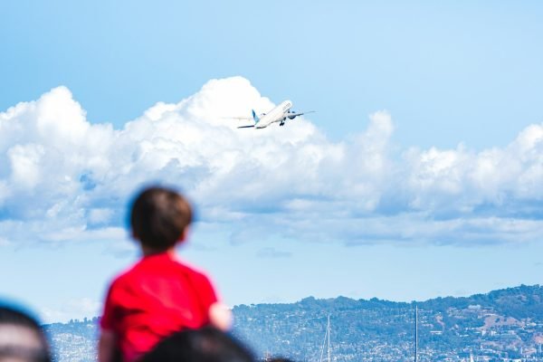 Child watching an airplane take off from the airport