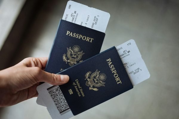 Parent holding two US passports before a family trip